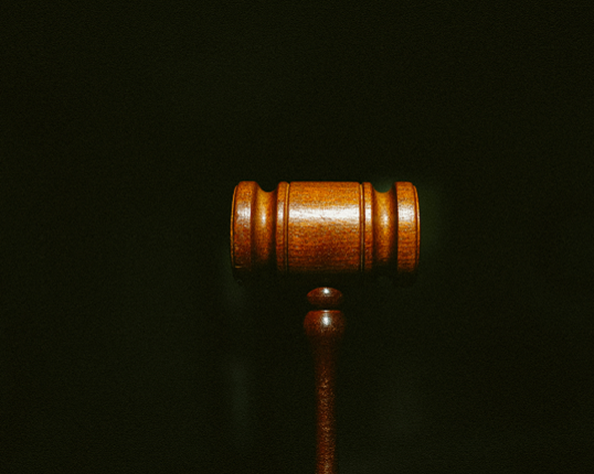 Photo of a judge's gavel on a black background