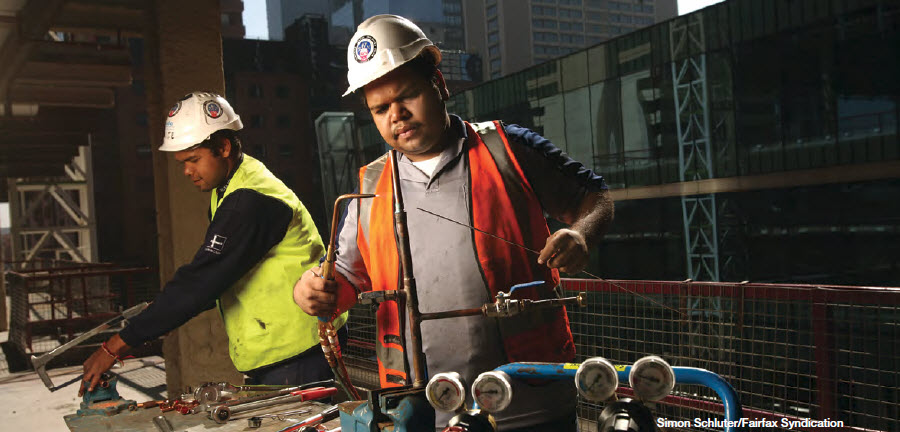 Aboriginal workers on industrial machinery