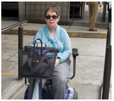 Person accessing ramp using mobility scooter