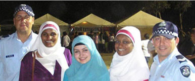 A photo of 2 policeman with 3 indigenous women