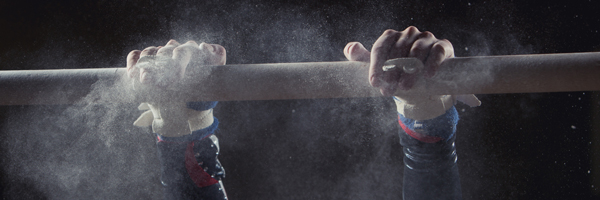 Gymnast clutching gym bar