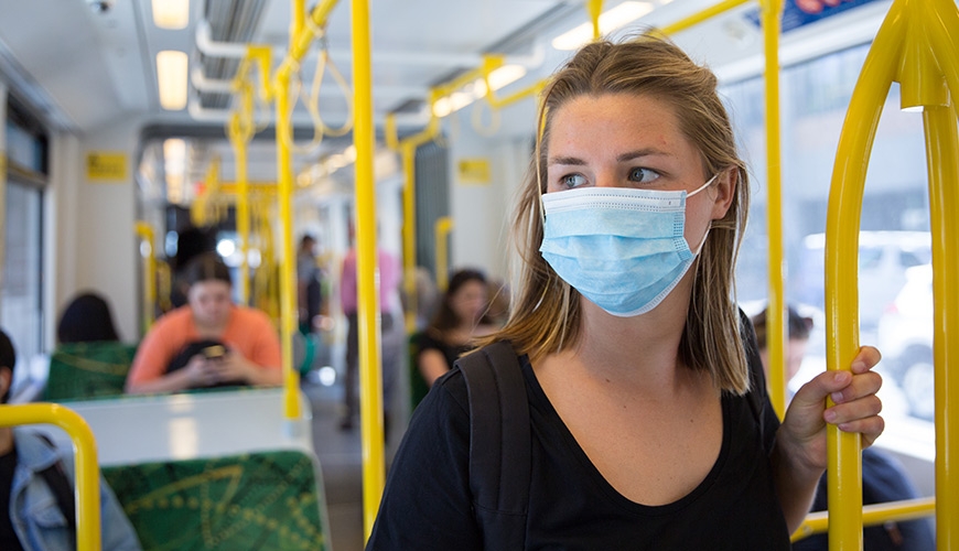 Woman on train in mask