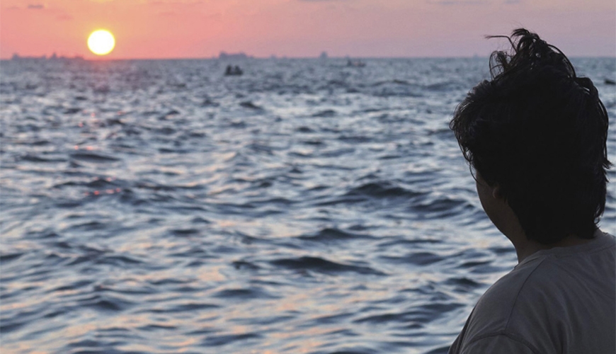 man looking out to sea