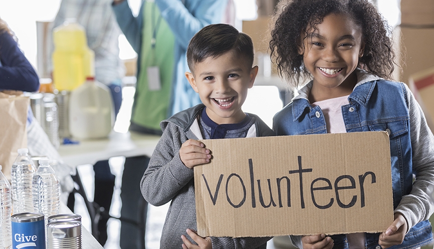 children with volunteer sign