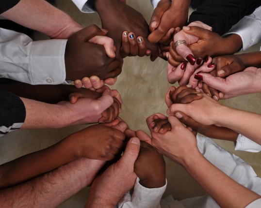 Multi racial group holding hands