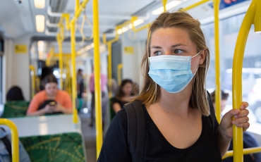 Woman on train in mask