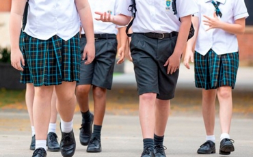 The legs of boys and girls in school uniform