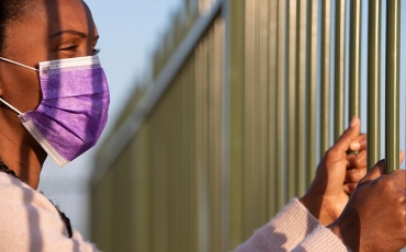 Person in detention centre in covid mask