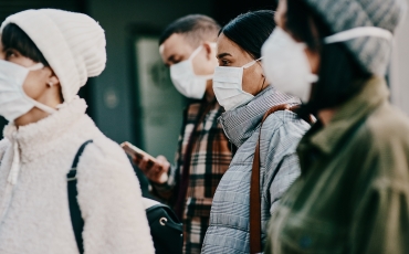 People standing in line wearing COVID-19 n95 respiratory masks