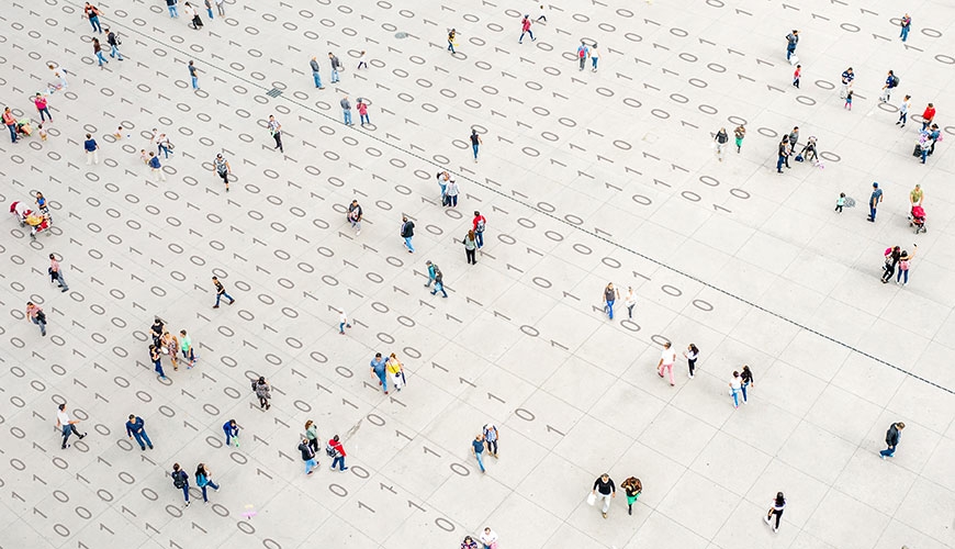 crowd walking over binary code