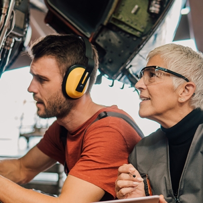 man and woman working on an aircraft