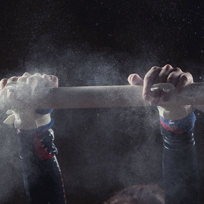 Gymnast swinging on bar