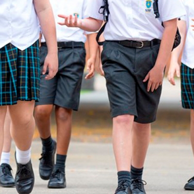 The legs of boys and girls in school uniform