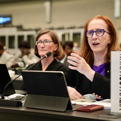 Commission Chief Executive Leanne Smith (left) with President Rosalind Croucher (right) seated at a meeting in Geneva.