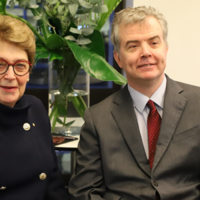 The Age Discrimination Commissioner the Hon Dr Kay Patterson AO, a woman wearing a navy jacket and glasses, sits next to the Disability Discrimination Commissioner Dr Ben Gauntlett, a man wearing a suit using a wheelchair.