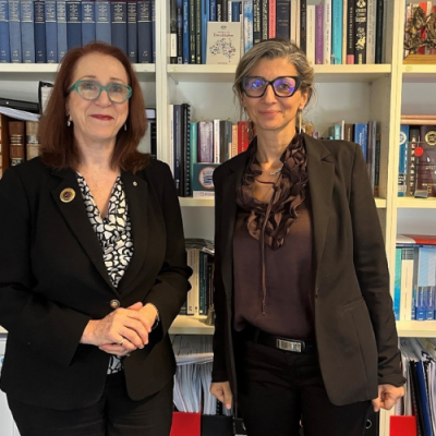 Commission President Emeritus Professor Rosalind Croucher AM, a woman wearing glasses and a black suit, standing next to Francesca Albanese, the United Nations Special Rapporteur on the situation of human rights in the Palestinian Territory occupied since 1967, a woman wearing a black suit and glasses.