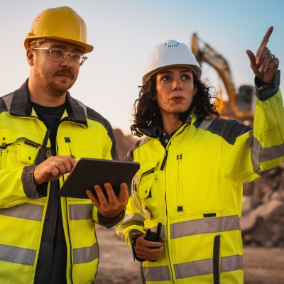 Multi racial man and woman working on mining site