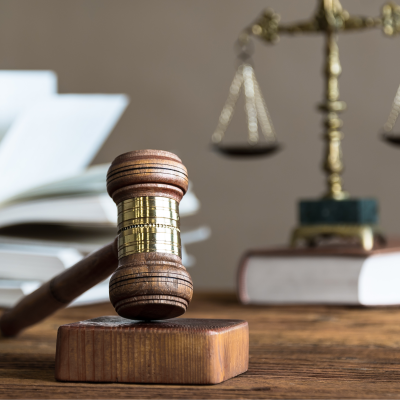 judge's gavel with legal scales and law book