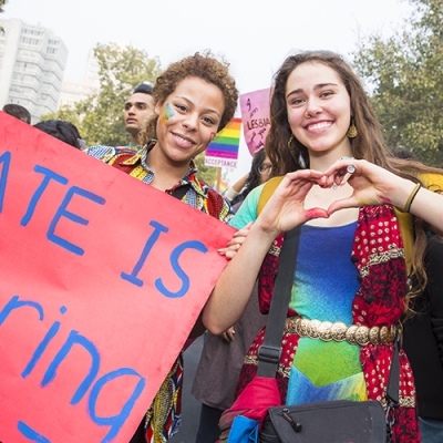 Pride parade with sign 'Hate is boring'